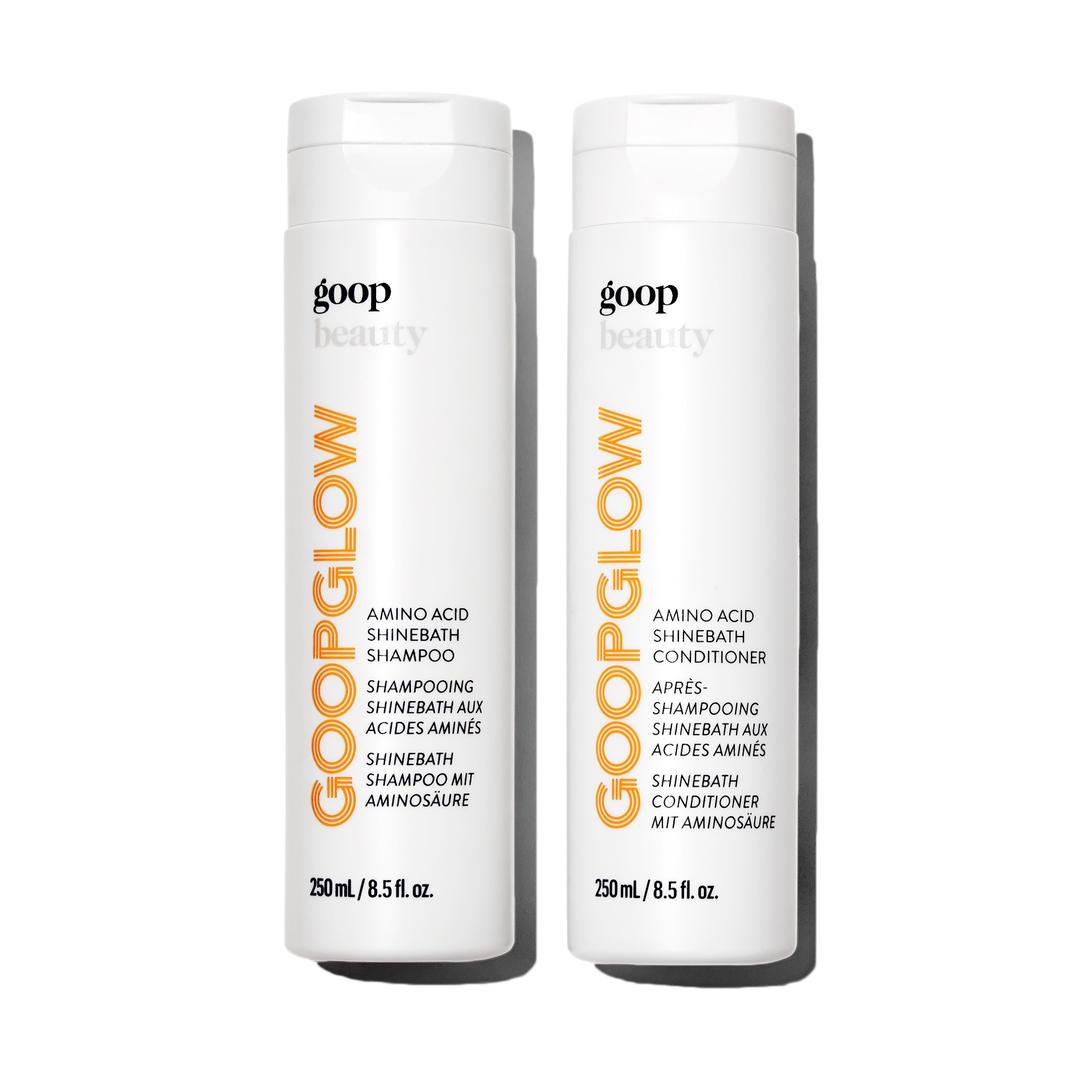 A white bottle of shampoo next to a white bottle of conditioner
